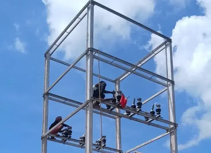 Electrical crew on a substation gantry structure